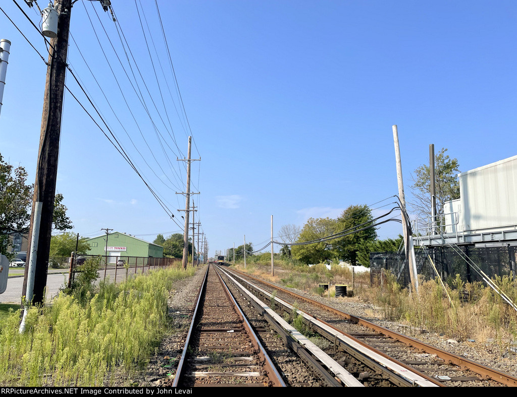 Looking east from the Long Beach Blvd Grade Crossing toward Long Beach. LIRR Train # 6816 is seen heading away in the distance.